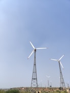 A wind farm with several turbines spinning in the breeze.