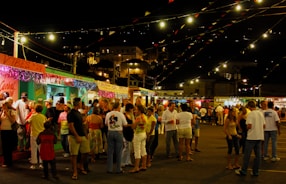 a crowd of people standing around a food truck