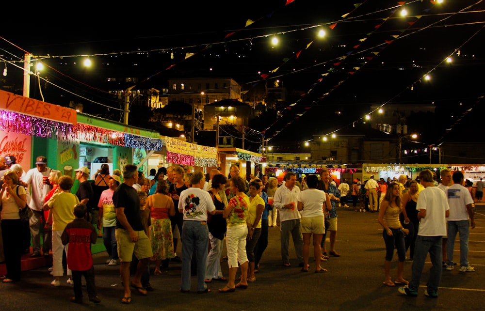 a crowd of people standing around a food truck