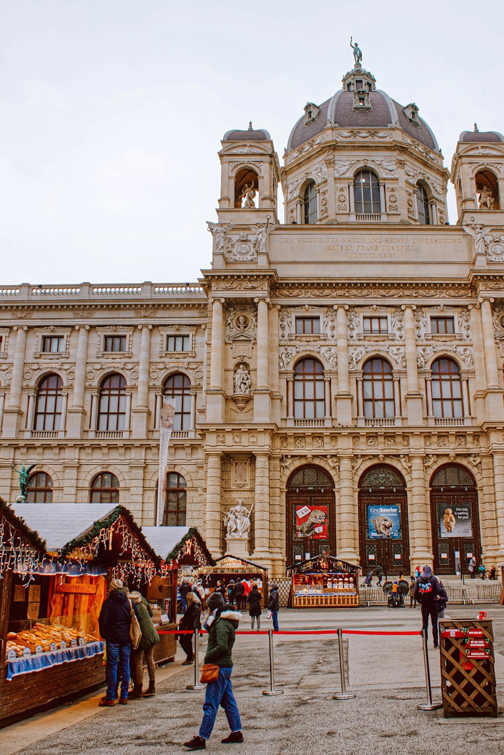 a group of people standing in front of a large building