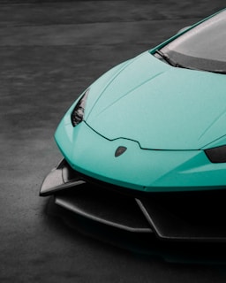 Side view of a sleek sports car with water beading off its freshly waxed surface.