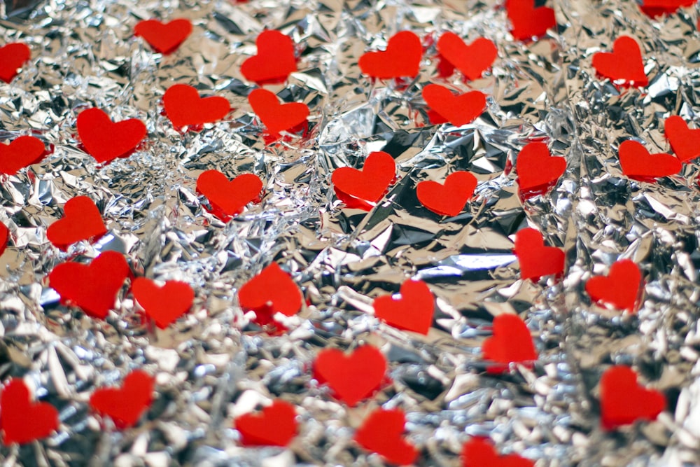 a bunch of red hearts sitting on top of tin foil