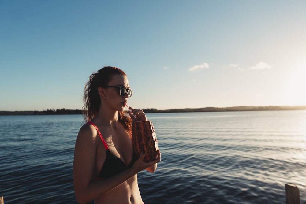 a woman in a bikini holding a baseball glove