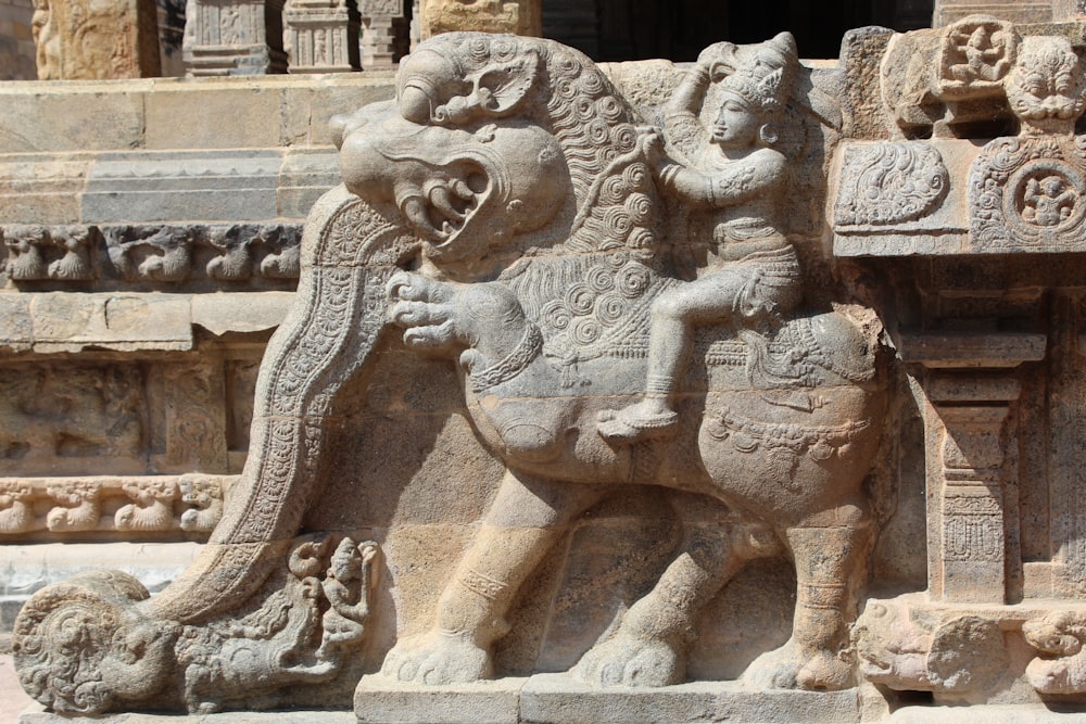 a statue of a man riding a horse in front of a building