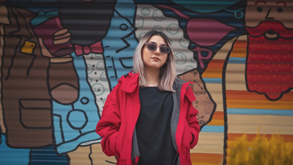 a woman standing in front of a colorful wall