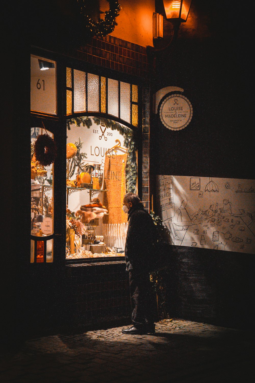 a man standing in front of a store window