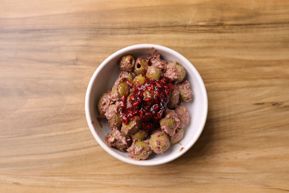 a white bowl filled with meat and vegetables