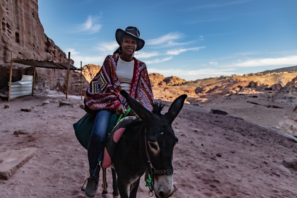 a man is riding a donkey in the desert