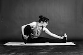 a woman is doing a yoga pose on a mat
