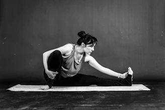 a woman is doing a yoga pose on a mat