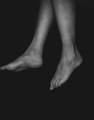 a black and white photo of a person's legs