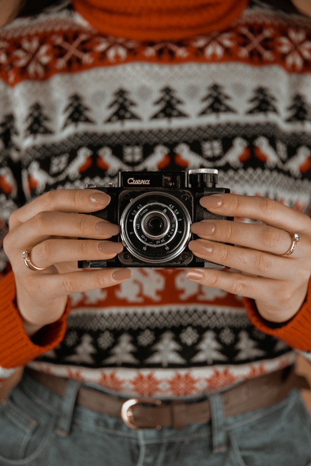 a woman holding a camera in her hands