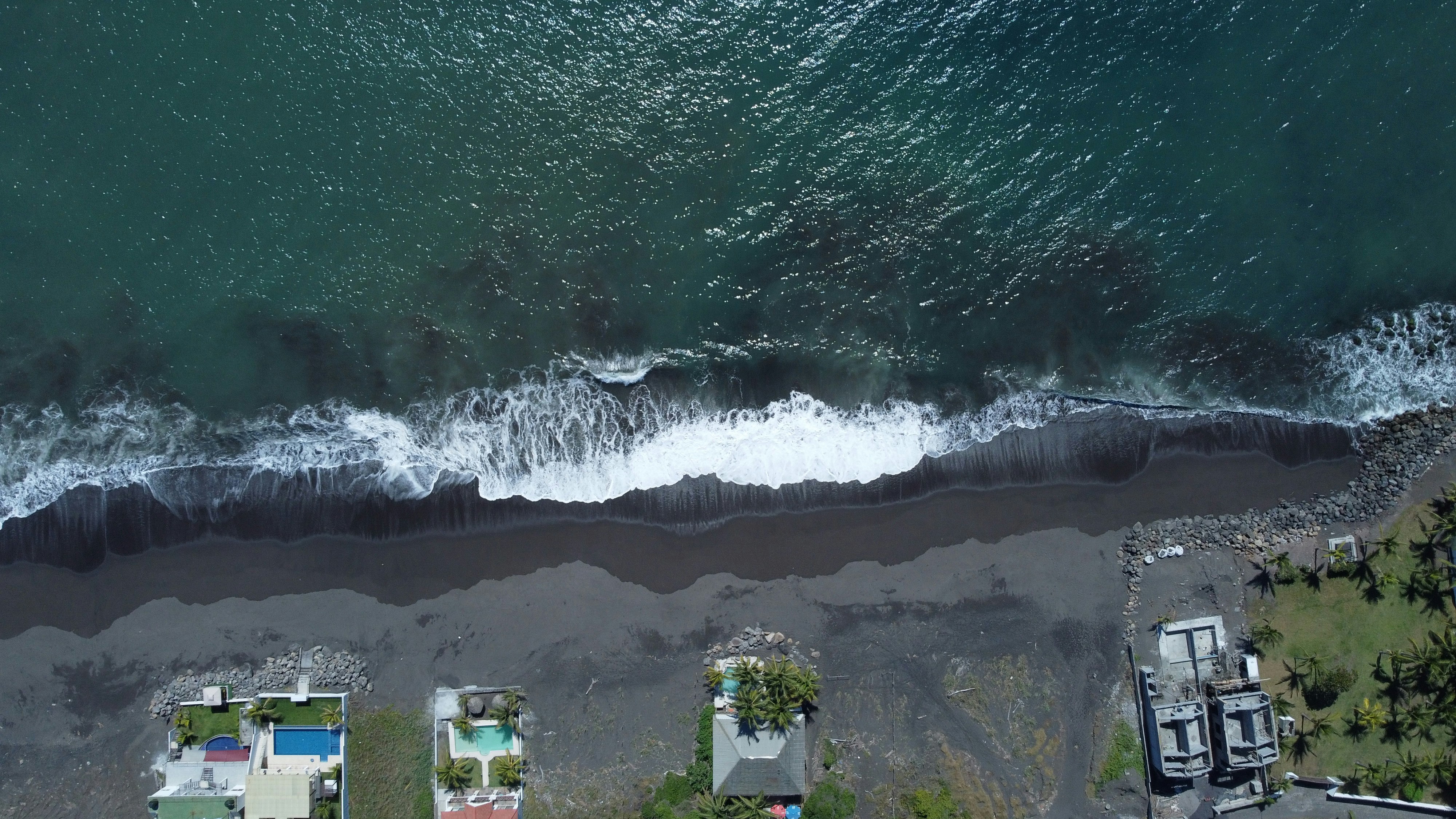 a person riding a wave on a surfboard in the water, 