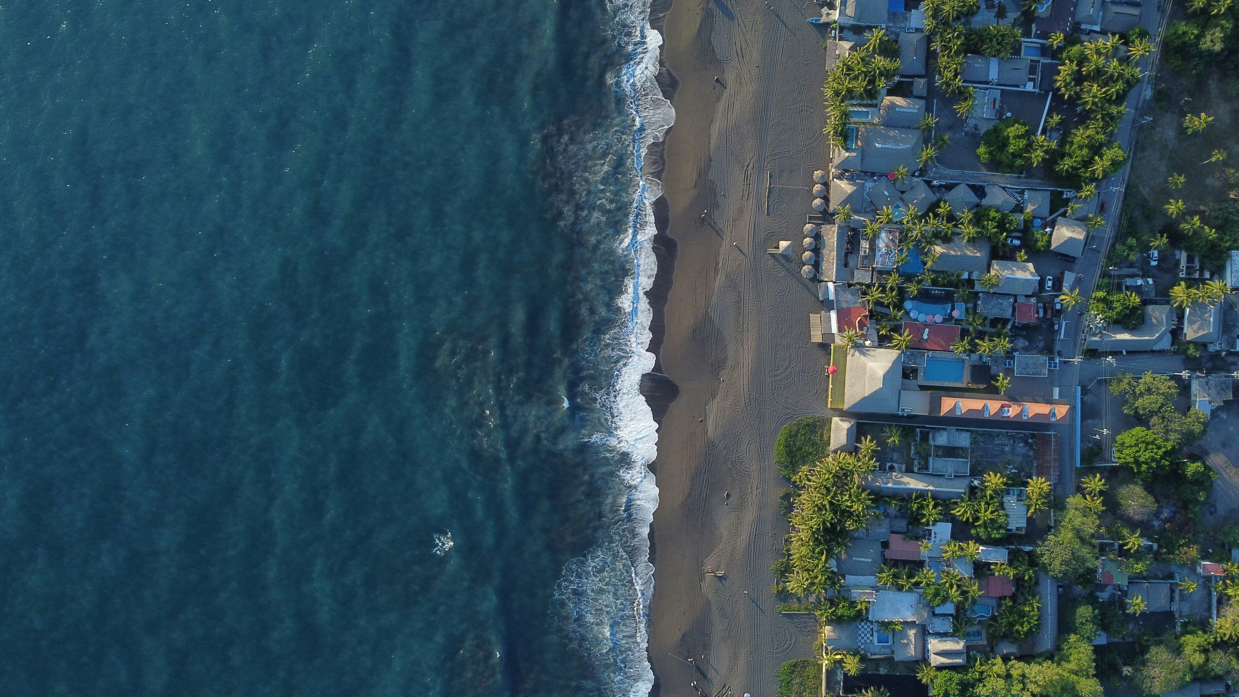 an aerial view of a beach with houses on it, 