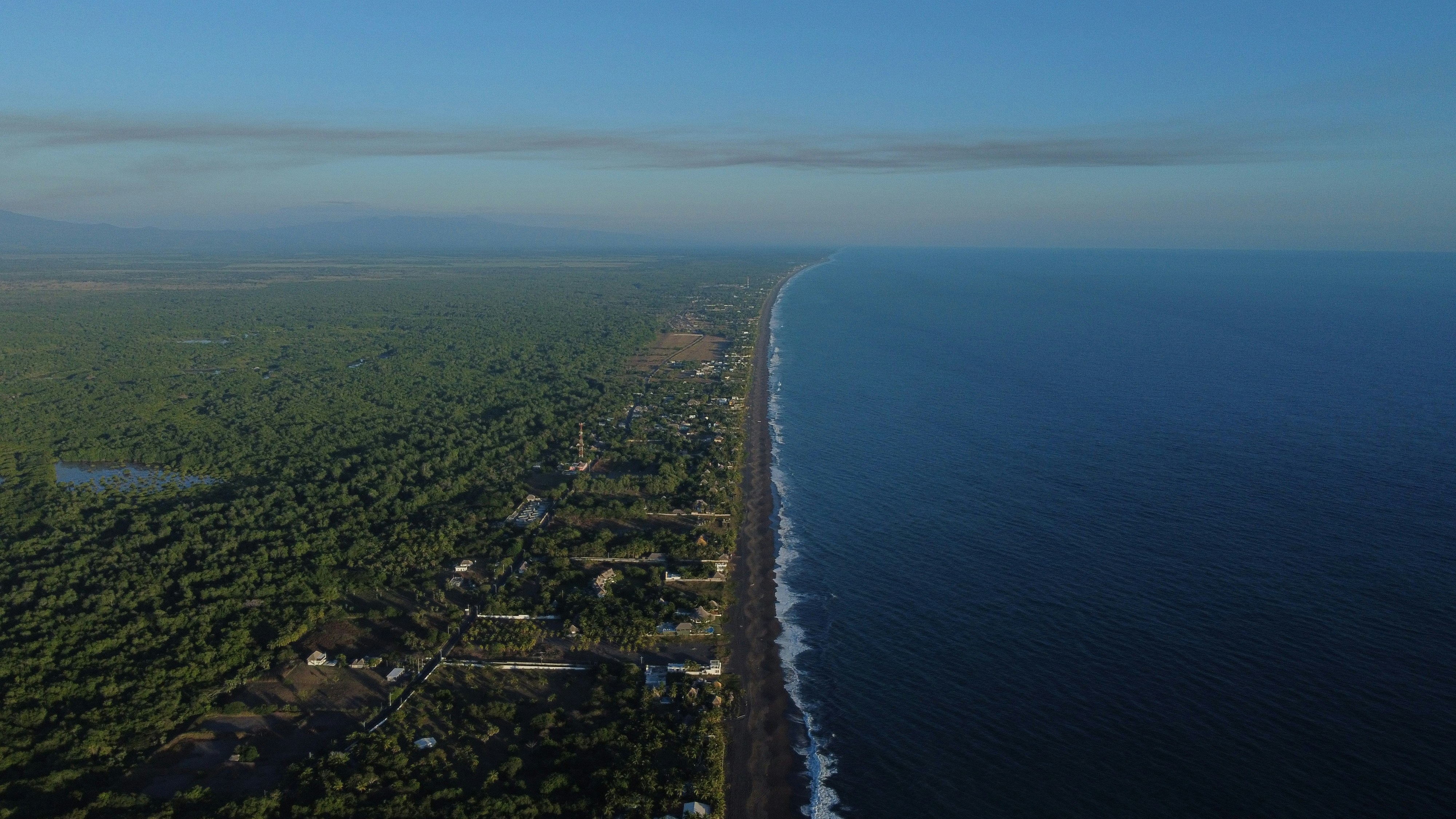 an aerial view of a beach and a body of water, 