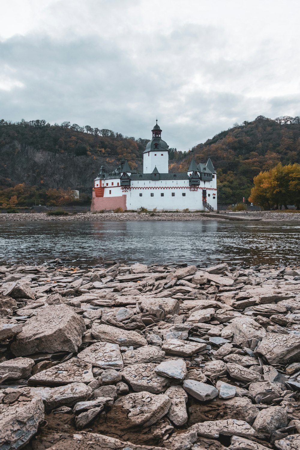 a large white building sitting on top of a river