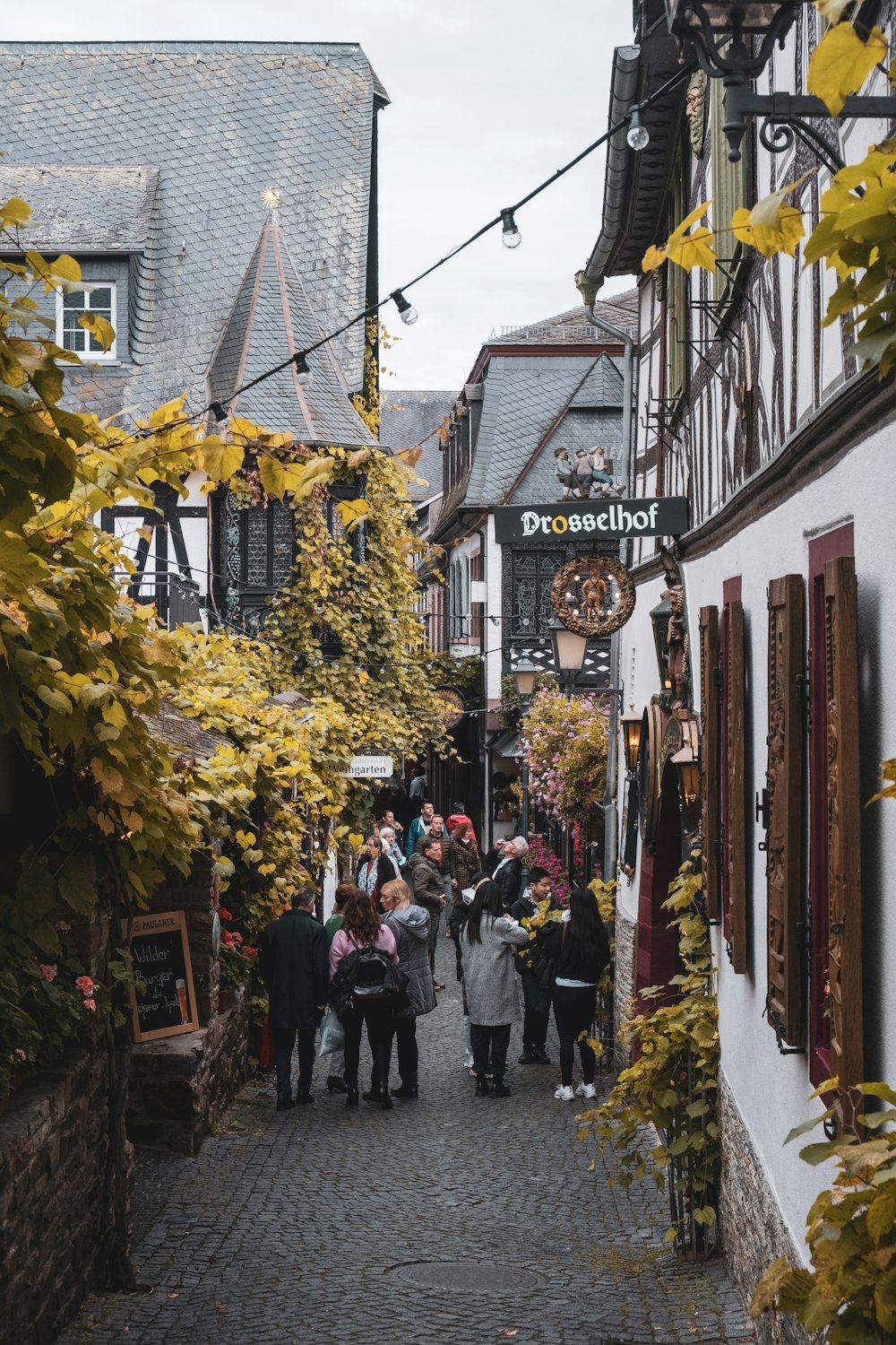 a group of people walking down a narrow street