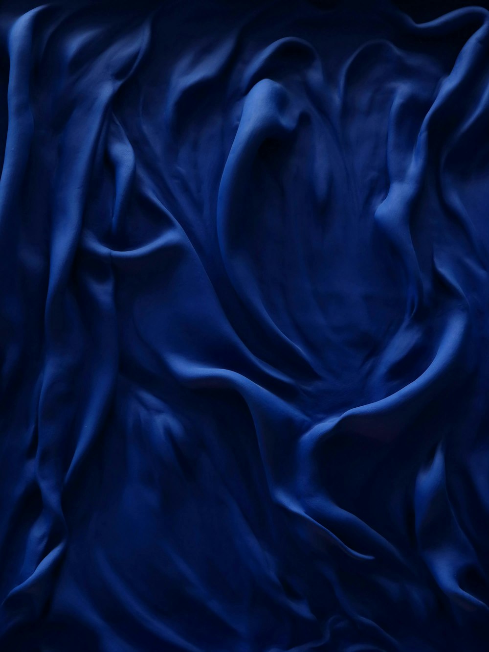 a dark blue background with a wavy pattern