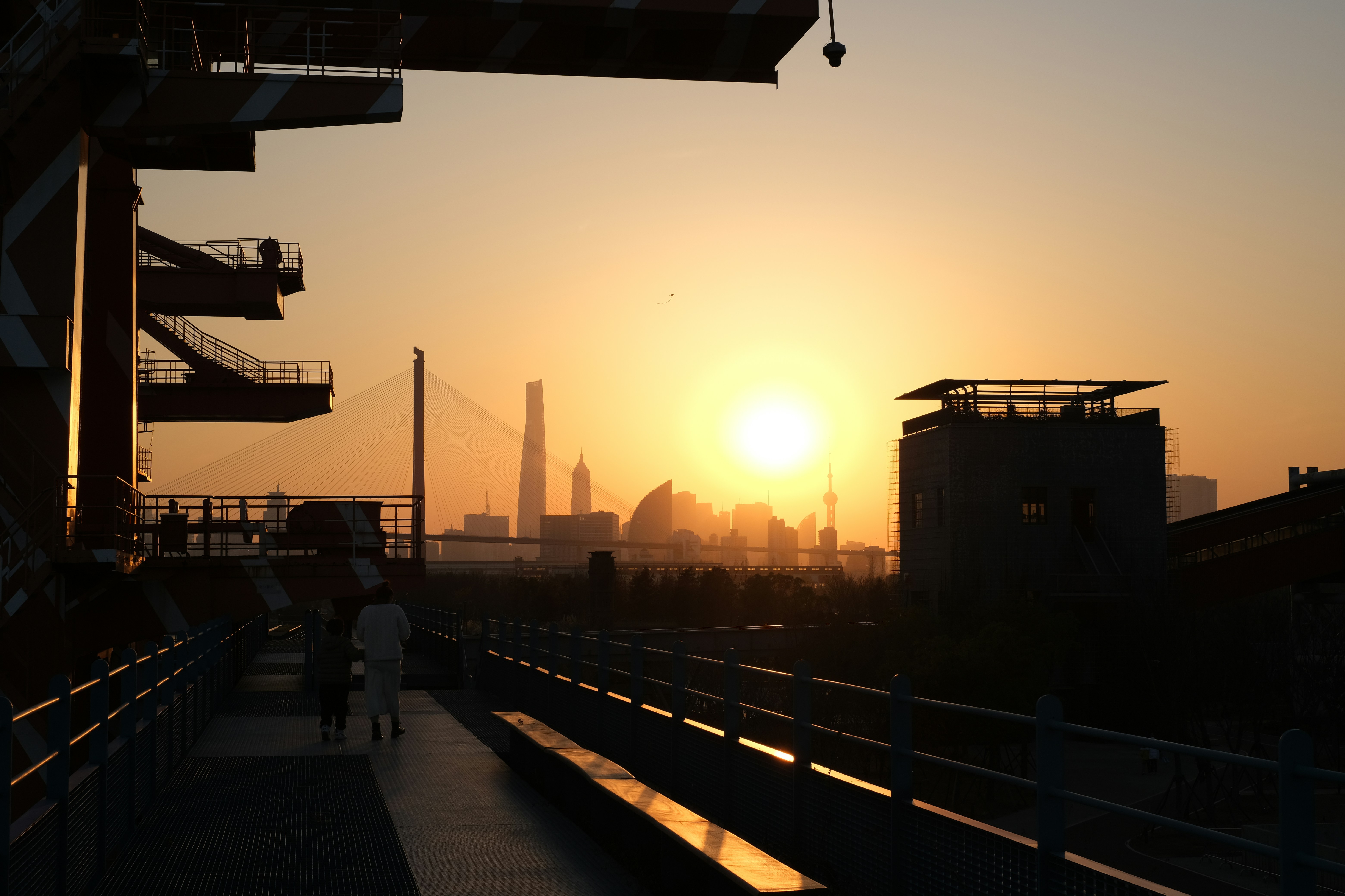 the sun is setting over a city skyline