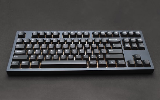 a black computer keyboard sitting on top of a table