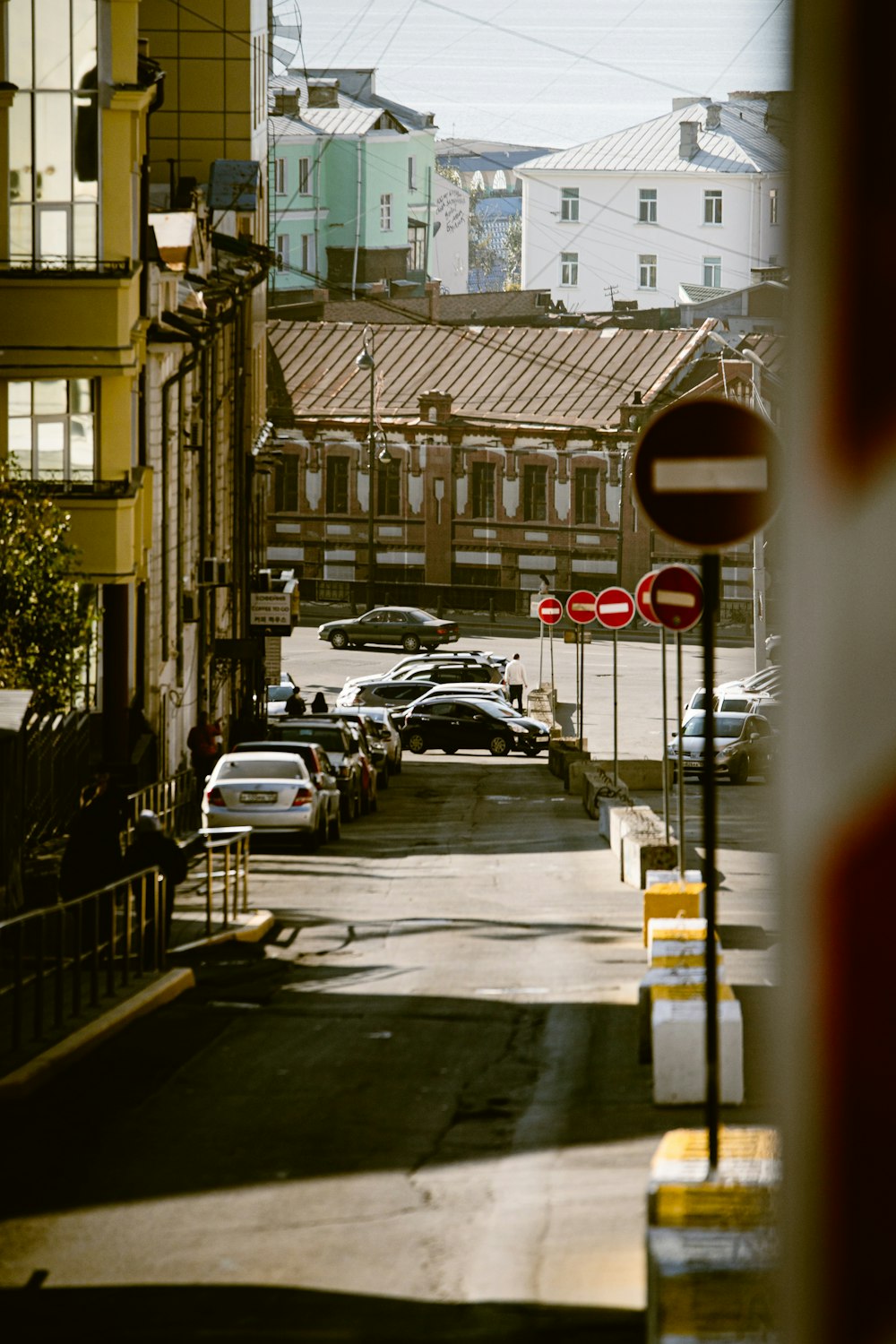 a city street with a few cars parked on the side of the road