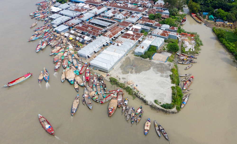 a large group of boats floating on top of a river