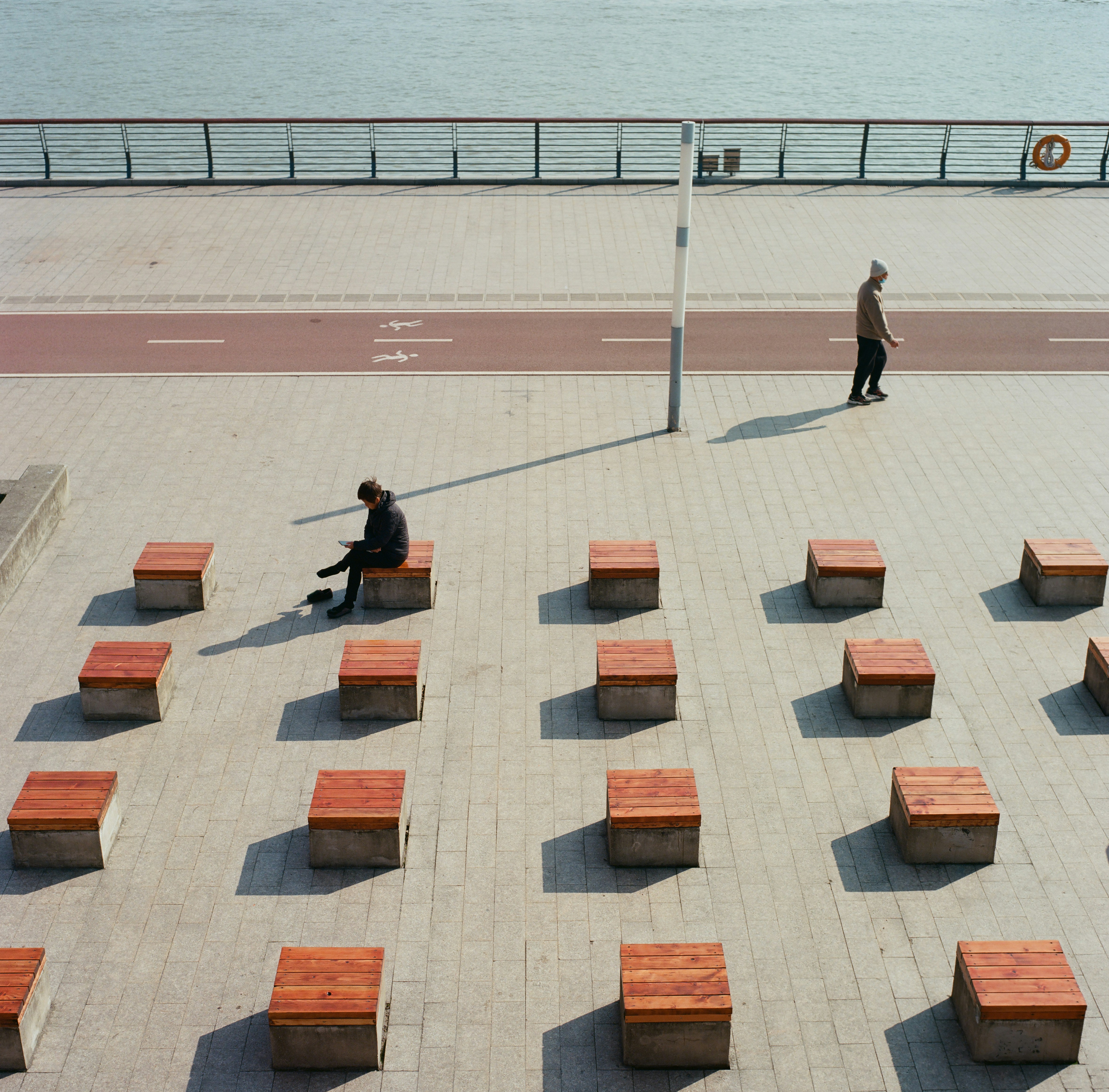 a couple of people sitting on top of wooden benches