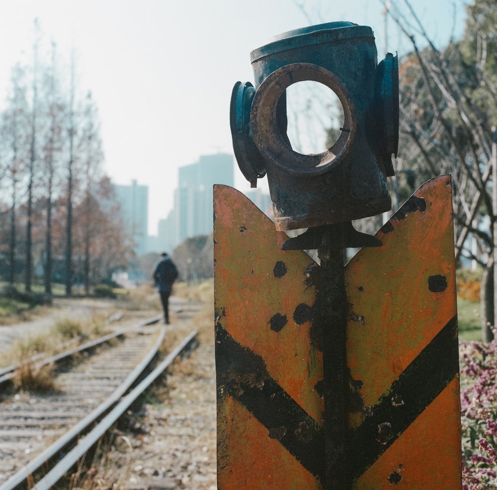 a man walking down a train track next to train tracks