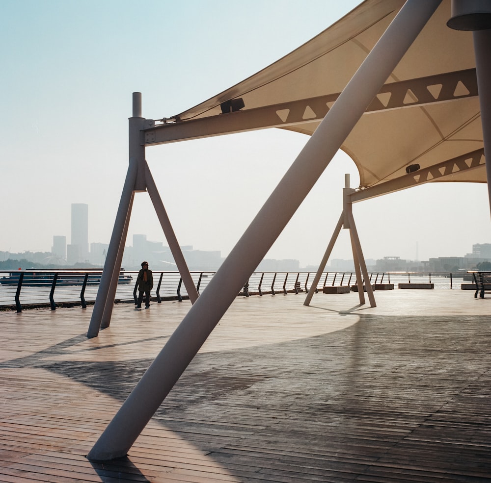 a couple of benches sitting on top of a wooden pier