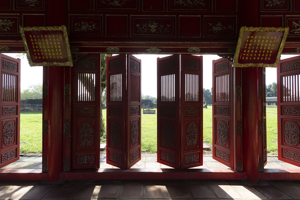 a group of red wooden doors sitting inside of a building