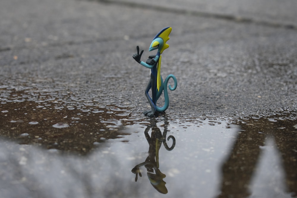 a glass figurine sitting in the middle of a puddle