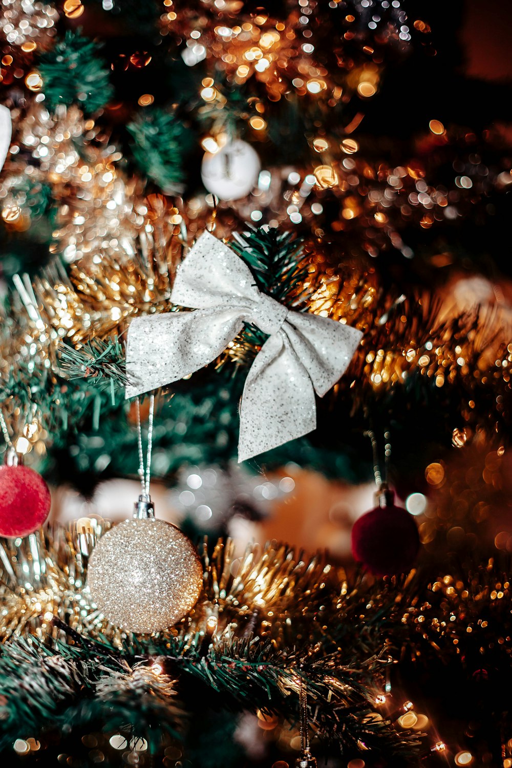 a close up of a christmas tree with ornaments