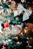 A festive Christmas tree topped with a handcrafted bow.