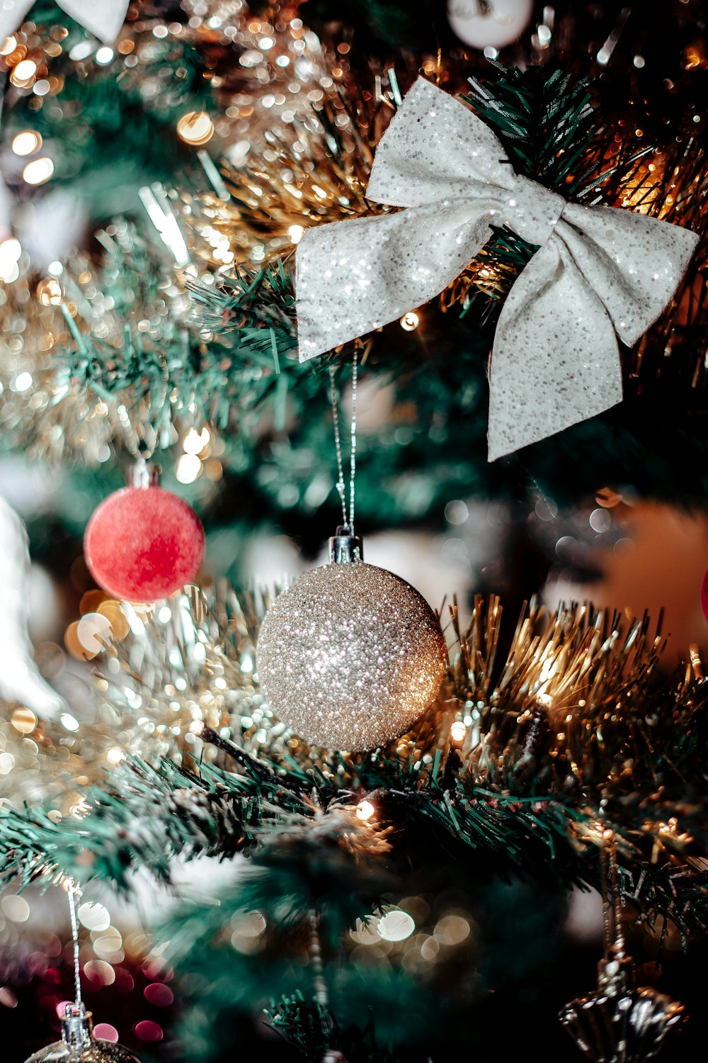 a close up of a christmas tree with ornaments