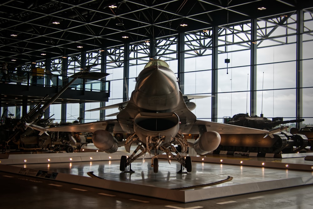 a fighter jet sitting inside of a hangar