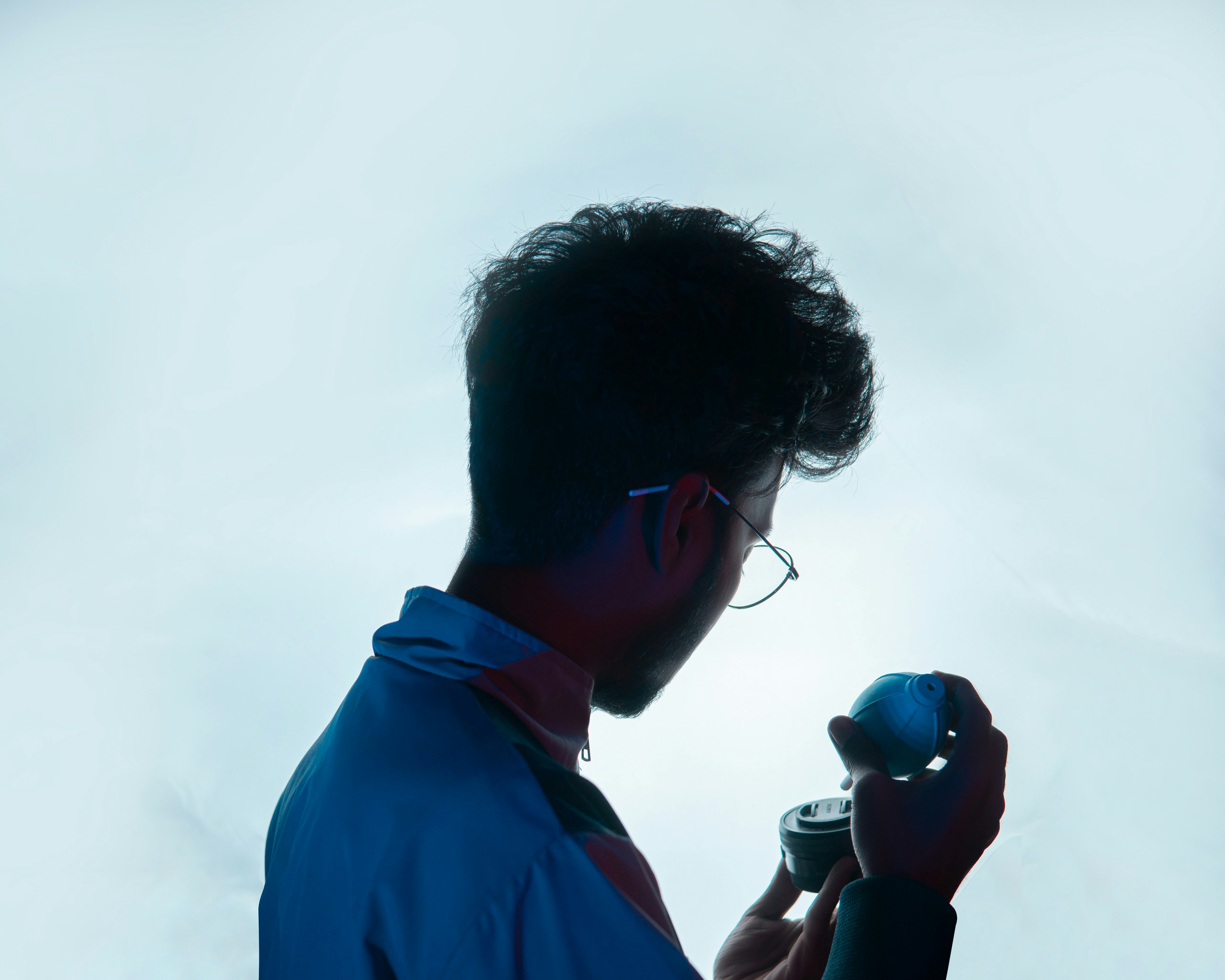 A person speaking into a microphone with sound waves emanating, illustrating voice generation