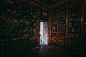 A dimly lit study room with leather-bound books and a flickering candle