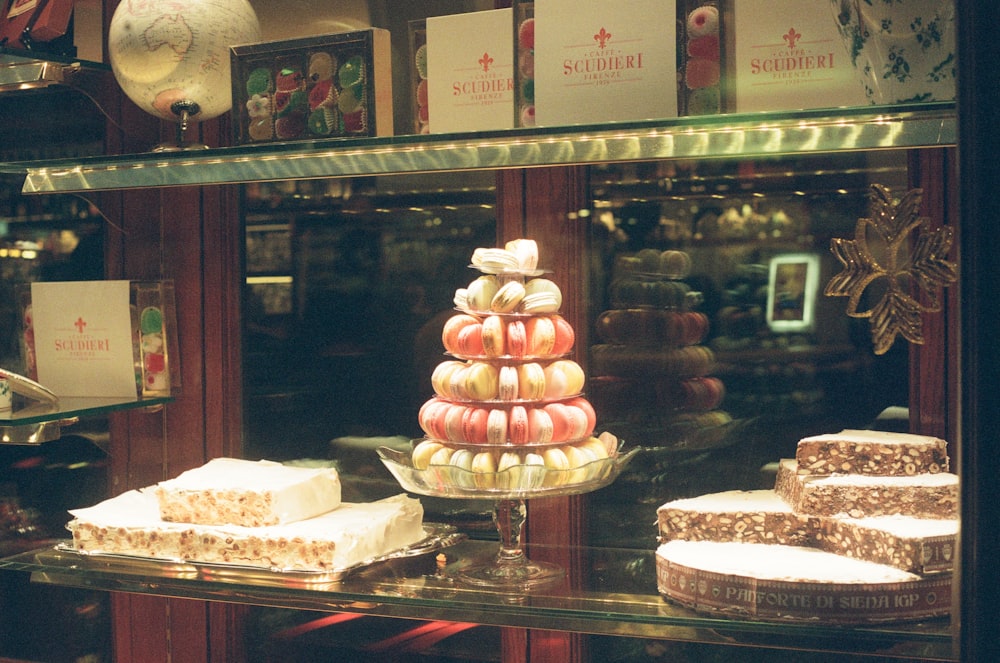a display case filled with lots of different types of cakes