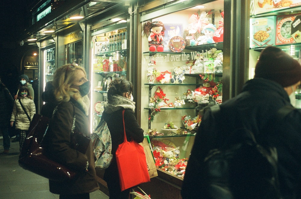 a group of people standing in front of a store