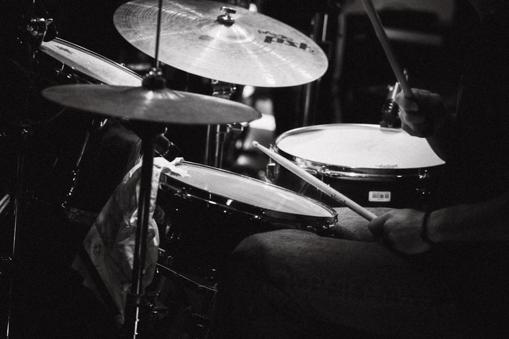 a person playing drums in a dark room