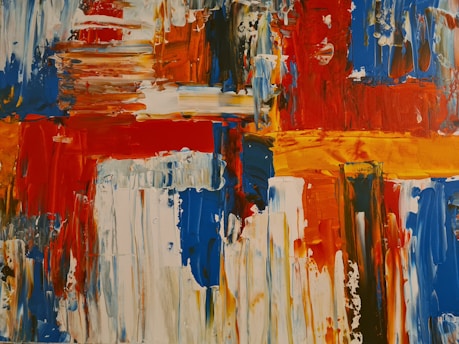 Bold, abstract art featuring vibrant blocks and strokes of color, including red, blue, orange, and white. The painting consists of thick, textured brushstrokes and dynamic patterns that evoke movement and energy.