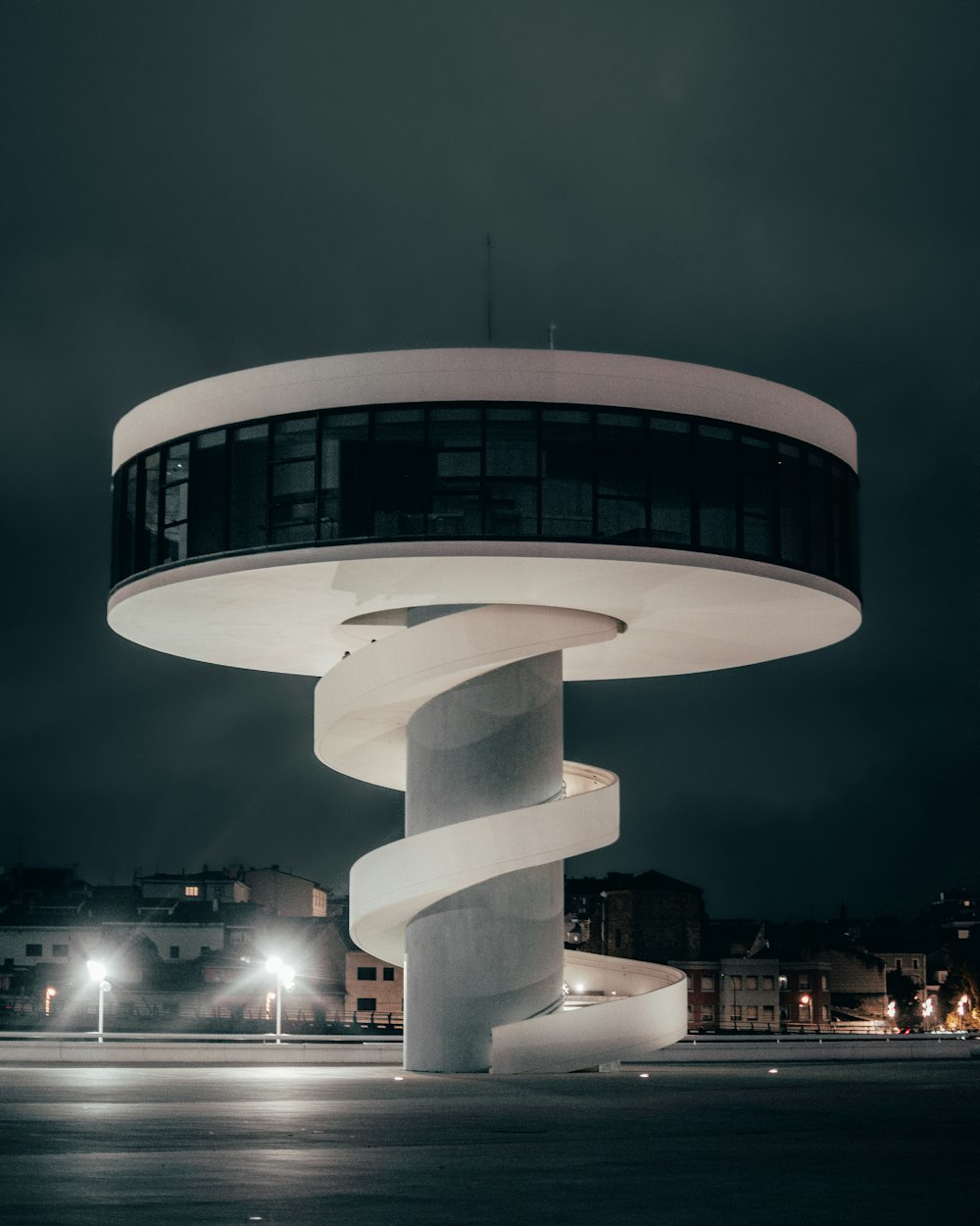 a building with a spiral design in the middle of a street