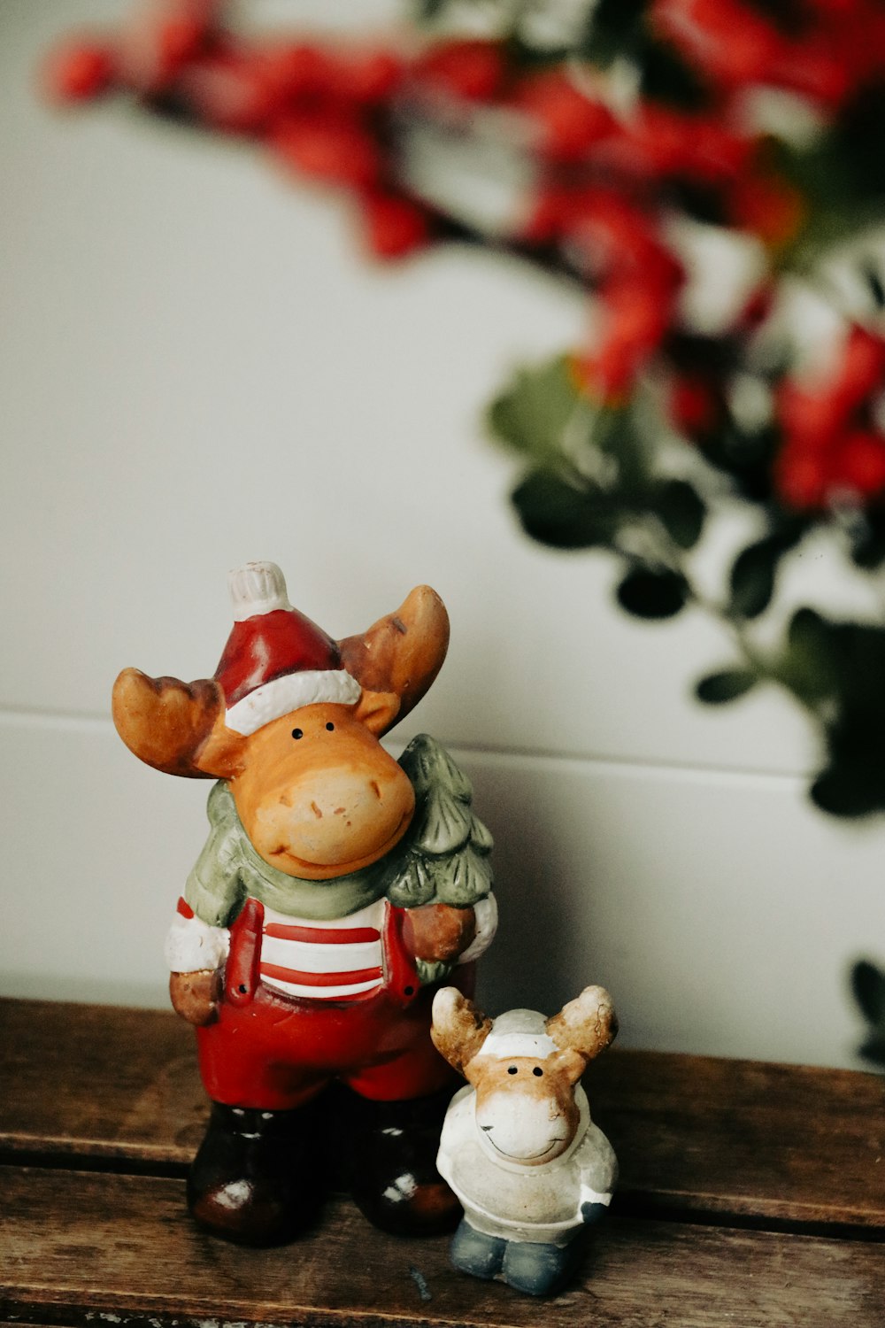 a couple of small figurines sitting on top of a wooden table