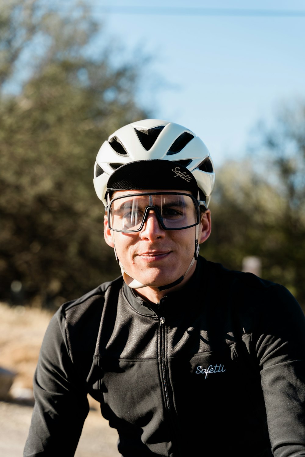 a man riding a bike wearing a helmet and goggles