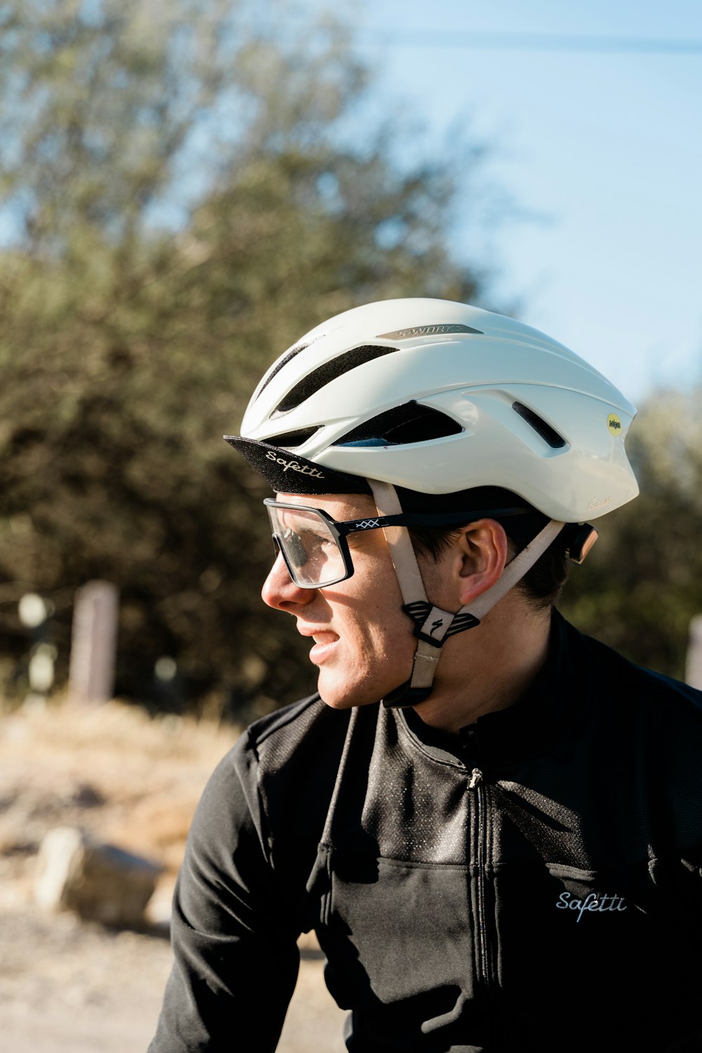 a man riding a bike down a dirt road