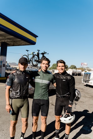 A group of happy local drivers posing with their new Canvolt electric tricycles under a bright African sky.