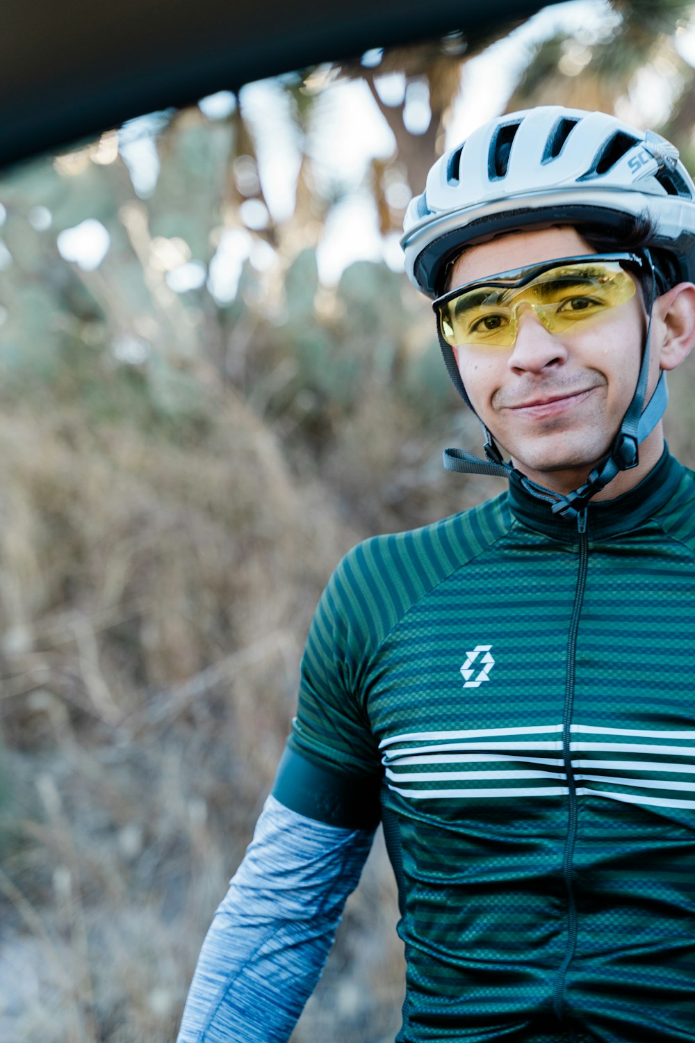 a man wearing a bike helmet and sunglasses