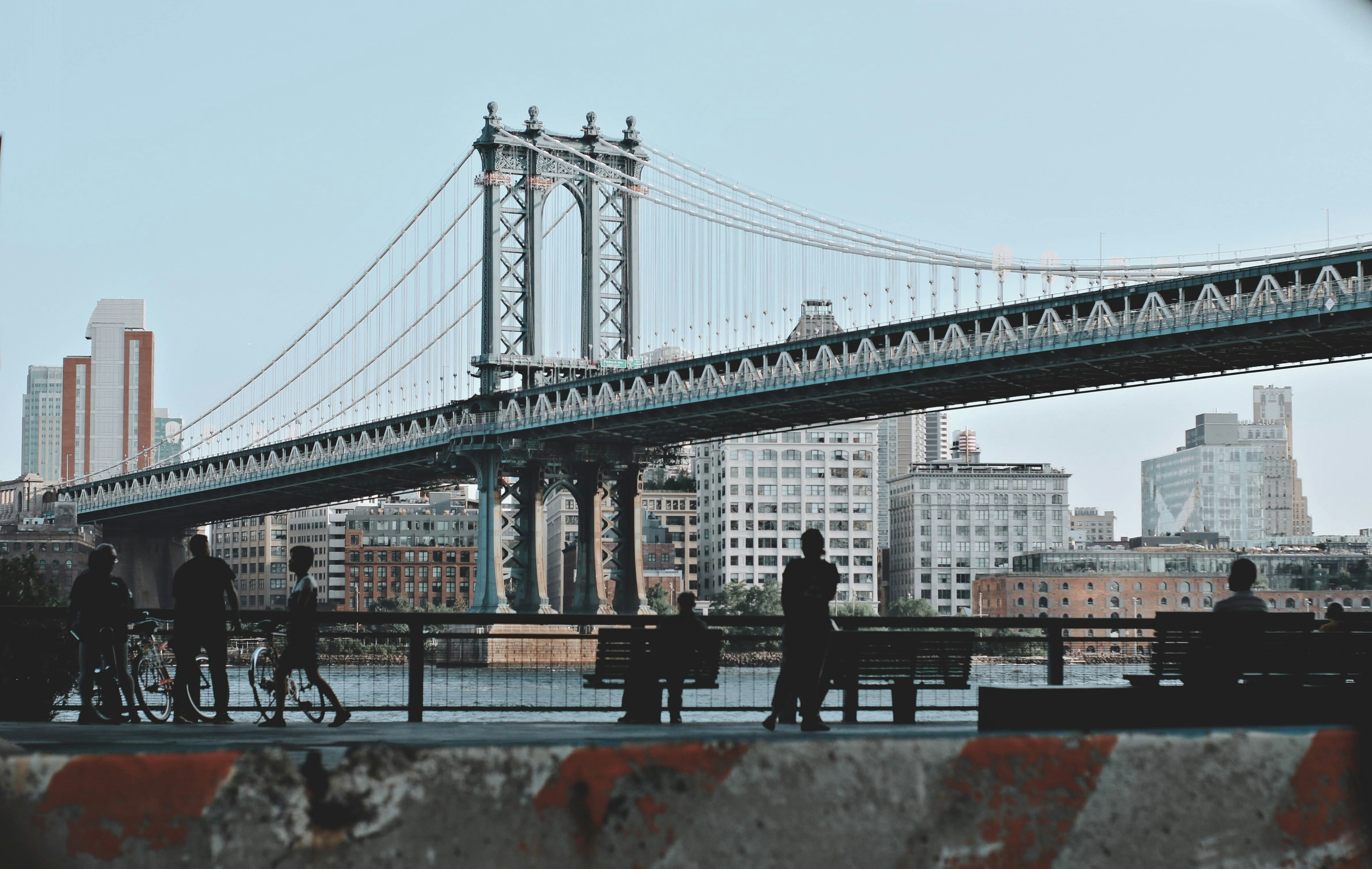 a group of people riding bikes across a bridge