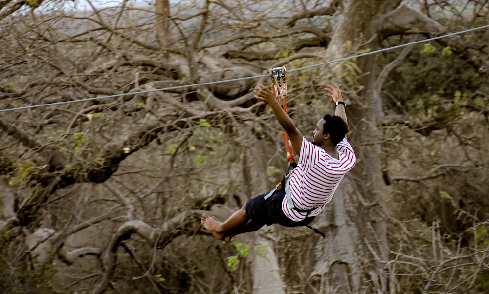 a man on a rope high up in the air