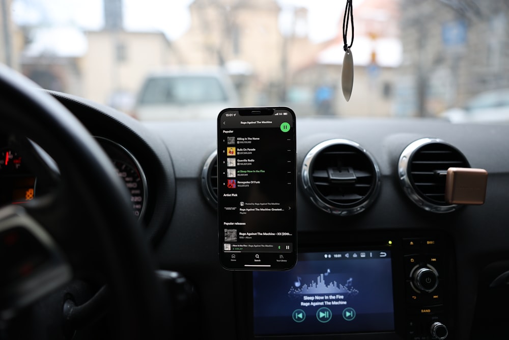 a car dashboard with a cell phone and gps